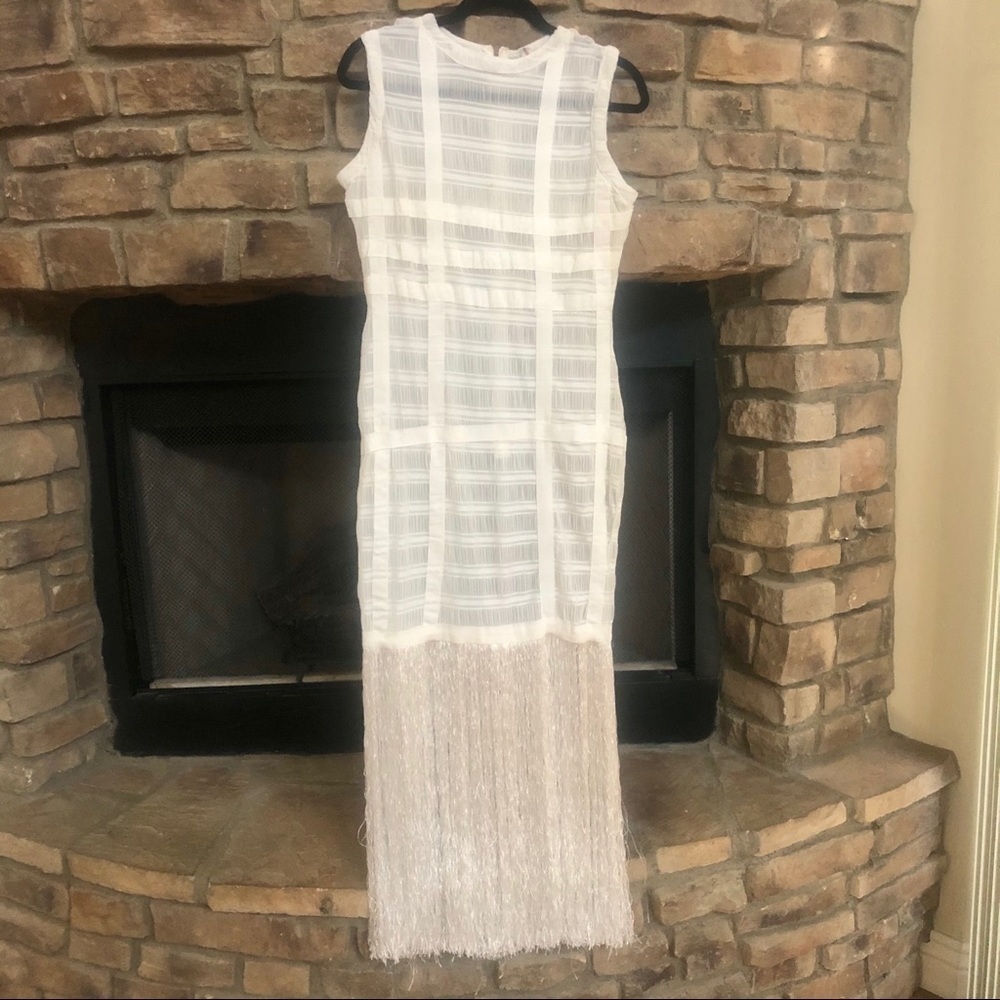 Long white sleeveless dress with fringe.  Dress is see-through.  Large